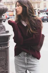Sweater de punto color borgoña con escote en V y mangas largas.