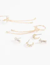 Set de tres pares de caravanas plateadas con strass: un par de aros tipo botón con forma de barra, un par de aros pequeños con forma de media luna y un par de aros colgantes con forma de estrella y cadena.