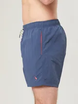 Short de baño celeste con cintura elástica y cordón ajustable.