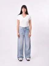 Remera blanca de punto con cuello en V y mangas cortas con volados.