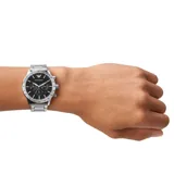 Reloj Emporio Armani con caja de acero inoxidable plateado de 43mm, esfera negra con acabado sunray, subesferas de cronógrafo, ventana de fecha a las 4, manecillas e índices plateados, correa de acero inoxidable plateada con cierre desplegable y resistencia al agua de 3 ATM.