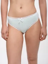 Colaless blanca de algodón con terminaciones de puntilla negra y moño decorativo.