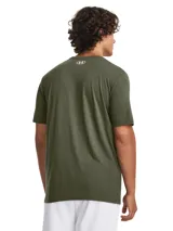 Remera blanca de Under Armour con estampado camuflado en el pecho y logo de la marca en negro.