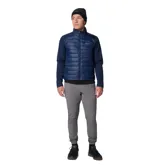 Chaqueta híbrida Columbia para hombre, color azul marino, con cuerpo acolchado y mangas de softshell. Presenta cierre frontal completo, cuello alto y logo de Columbia en el pecho.