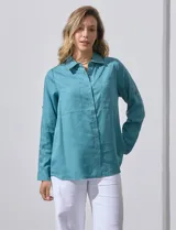 Camisa blanca de lyocell, marca Dash. Tiene cuello con solapa, abertura central con botones, mangas largas regulables con presilla y botón, y dos bolsillos delanteros aplicados.