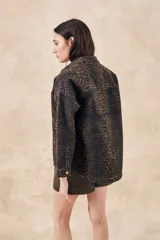 Sobrecamisa de denim con estampado de leopardo, calce oversize y botones frontales.