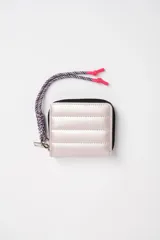 Billetera pequeña rosa con diseño capitoneado y cierre de cremallera. Incluye llavero de cordón trenzado con terminales plásticas rosas.