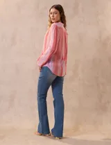 Blusa de gasa estampada con cuello a la base, escote en V y botones. Delantera con detalle plisado y mangas largas regulables con presilla y botón.