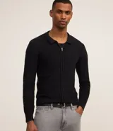 Suéter negro de algodón con textura de cuadros, corte boxy, cuello inglés, cierre con cremallera, mangas largas ajustadas y bajo ajustado.