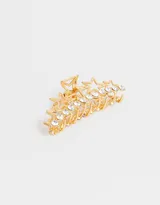 Broche dorado para el pelo con forma de pinza y diseño de estrellas con strass.