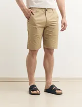 Bermuda de gabardina color verde con bolsillos laterales y traseros.