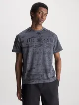 Remera gris con estampado abstracto en negro y logo de Calvin Klein en el pecho.