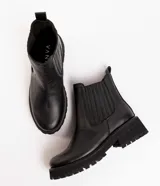 Botas Chelsea color marrón de cuero, con elástico lateral y suela track negra.