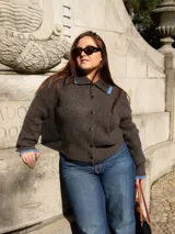 Cárdigan marrón de tejido con relieve, cuello camisero con borde celeste, cierre frontal con botones y calce relajado.