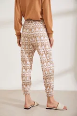 Jogger con estampado geométrico en tonos beige, con cintura elástica y dobladillo en los tobillos.