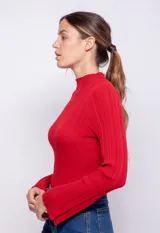 Polera de símil cuero con cuello alto y mangas largas acampanadas, color marrón.