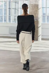 Pantalón culotte color crema, de tiro medio y pierna ancha. Incluye cinturón marrón con hebilla metálica.