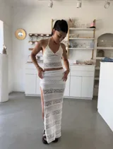 Conjunto de top halter blanco de encaje con falda larga al tono, con abertura lateral.