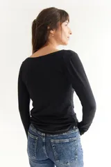 Remera gris de algodón con escote amplio tipo bote y mangas largas.