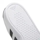 Zapatillas de cuero blanco con detalles en negro y diseño clásico de tres franjas.