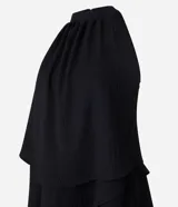 Vestido corto negro con escote halter y volados superpuestos en la falda.