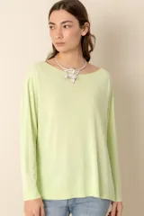 Sweater verde claro liso de manga larga con cuello bote y aberturas laterales.
