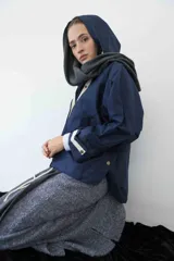 Campera impermeable de color azul marino con capucha y detalles de botones.