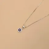 Conjunto de collar y dije con forma de ojo turco, realizado en plata 925 y circonias.