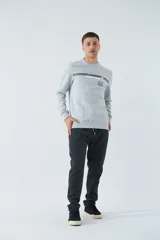 Buzo gris melange de algodón con cuello redondo, puños y cintura acanalados. Estampado frontal con el logo de la marca.