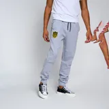 Pantalón de jogging negro con puños ajustados, cintura con cordón ajustable y escudo del Club Atlético Peñarol bordado en amarillo en el muslo izquierdo.