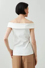 Remera blanca de manga corta con escote Bardot (hombros descubiertos) y calce ajustado.