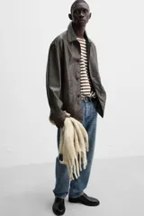 Pantalón de jean gris de corte recto, con cinco bolsillos, efecto lavado y cierre frontal con botones.