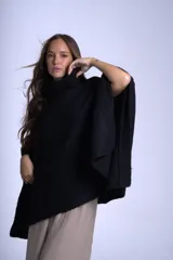 Poncho polerón negro tejido con cuello alto y mangas 3/4.