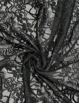 Top negro de manga larga, tejido en encaje con escote en V y borde festoneado. Diseño cruzado con lazos largos para atar a la cintura.