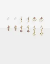 Set de seis pares de aros dorados con strass rosado, que incluyen aros tipo argolla y aros con pasantes.