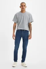 Pantalón de jean azul oscuro, corte skinny taper, con tiro medio y confeccionado en tejido stretch.