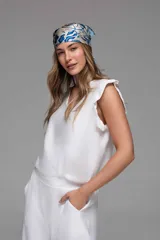 Musculosa blanca con escote en V y volados en los hombros.
