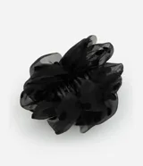 Pinza para el pelo negra con revestimiento de tela de poliéster con estampado de lunares.