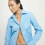 Collar de cadena de bolas de aleación de metales bañada en plata de ley, con un dije central en forma de corazón estilizado, bañado en oro 18k.