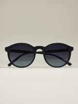 Lentes de sol de acetato negro con forma redonda y lentes degradadas.