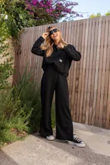 Buzo canguro negro de jogging con capucha y bolsillo delantero.