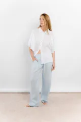 Camisa blanca de lino con cuello clásico y mangas cortas amplias.