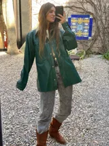 Campera de cuero marrón con cuello clásico, cierre frontal con botones y bolsillos con solapa.