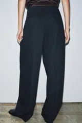 Pantalón de vestir azul marino con raya diplomática, tiro medio, corte wide leg, pinzas delanteras, bolsillos traseros y cierre frontal con cremallera y doble botón. Colección Zara Woman.
