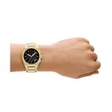 Reloj Armani Exchange modelo Sync, con caja dorada de acero inoxidable de 42mm y esfera negra con detalles en blanco. Cuenta con movimiento de cuarzo, cronógrafo y resistencia al agua de 50 metros.