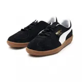 Championes Puma Palermo negros de gamuza con franja lateral blanca y suela marrón de goma.