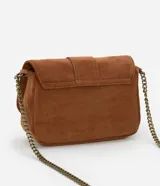 Bolso bandolera pequeño de gamuza marrón con solapa y cierre de hebilla dorada. Asa larga de cadena dorada.