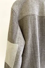 Camisa de hombre estilo leñadora con diseño patchwork en tonos beige y marrón. Presenta coderas, cartera americana y bolsillo ojal en el delantero. Confeccionada en lana fina sin teñir.