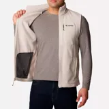 Chaleco de polar Columbia Fast Trek para hombre, color azul marino con cierre y detalles en azul eléctrico. Cuenta con cuello alto, bolsillos laterales con cierre y bolsillo en el pecho con cierre.