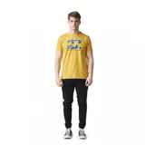 Remera amarilla de algodón con estampado gráfico de olas en azul y logo de Billabong.